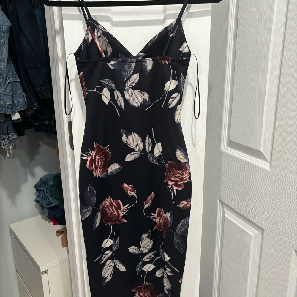 Black flowery dress that fits perfectly to the body